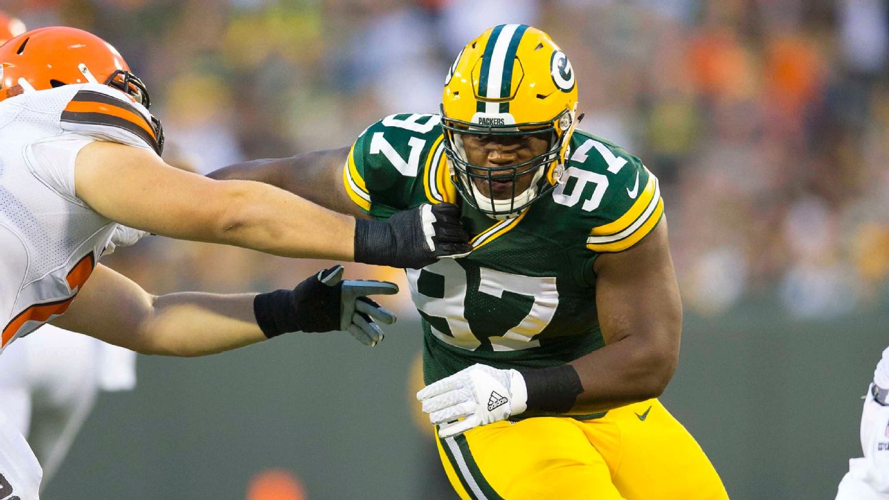 Packers lineman Kenny Clark surrounded by youngsters