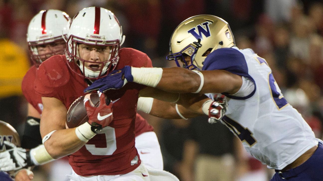 Christian McCaffrey of the Stanford Cardinal battles with Darrien