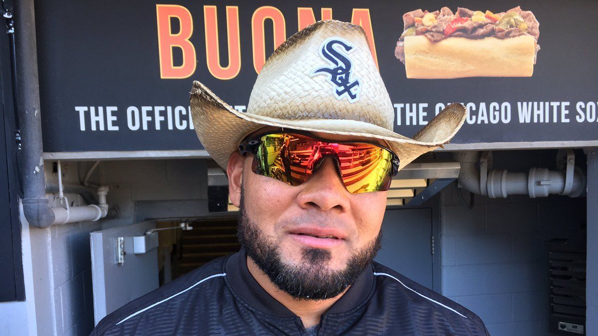 Melky Cabrera shows off his hitting skills by smashing a guitar to