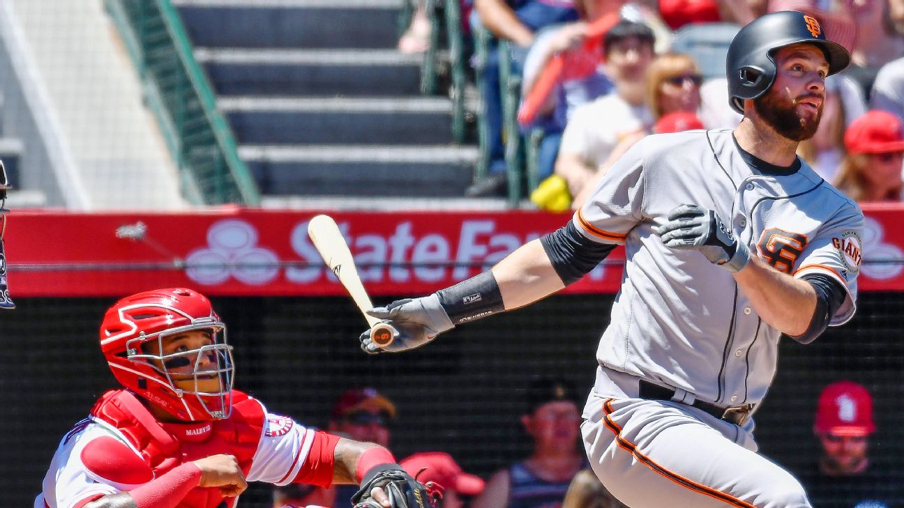 San Francisco Giants first baseman Brandon Belt, right, stands