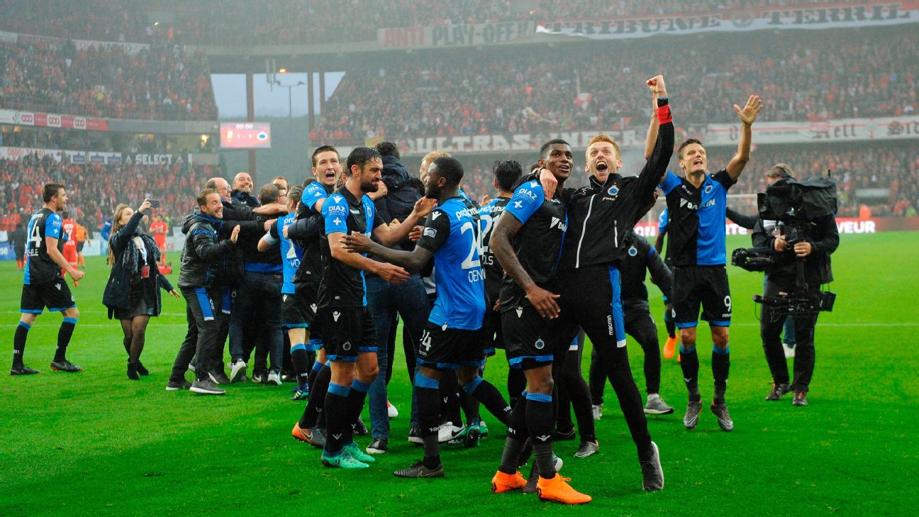 Club Brugge fans in the stands celebrate the result after the