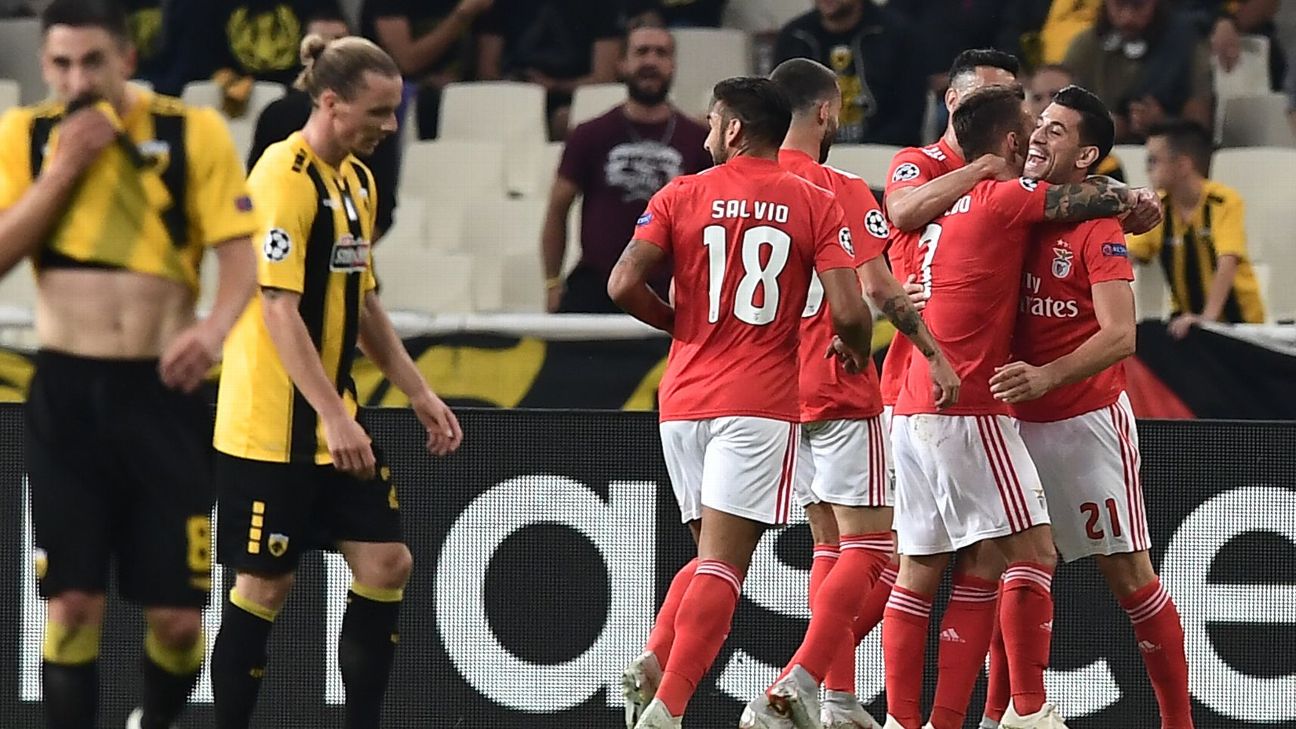 Benfica players celebrate after scoring a goal against AEK Athens in the Champions League.