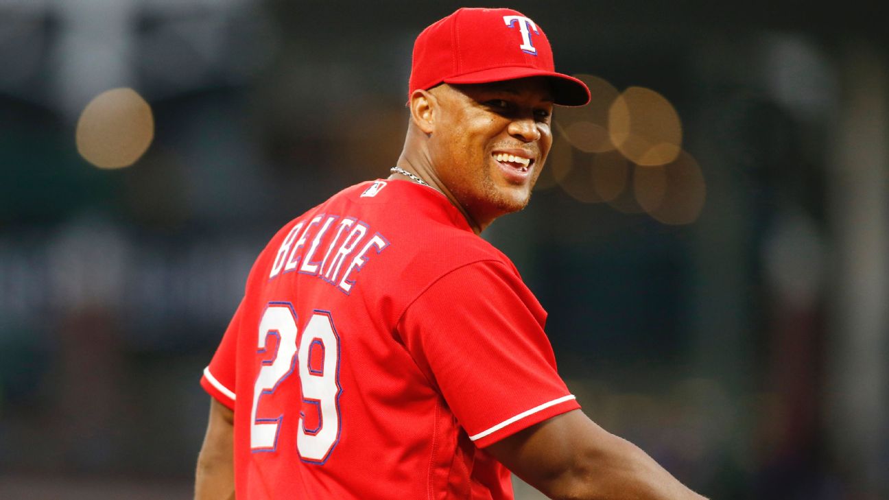 Seattle Mariners' Adrian Beltre smiles at teammate in the dugout