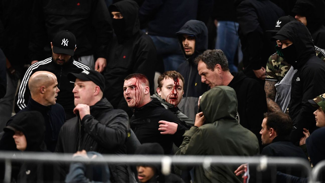 Ajax fans react after clashing with Greek riot police ahead of kick-off between Ajax and AEK Athens.