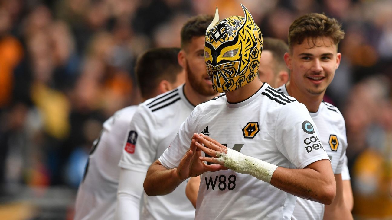 Wolverhampton Wanderers' Mexican striker Raul Jimenez wears a mask as he celebrates scoring his team's second goal during the  FA Cup semifinal football match against Watford.