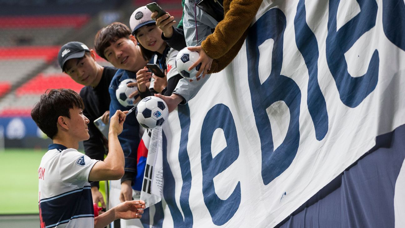 Inbeom Hwang signs autographs after the Vancouver Whitecaps' MLS match against the Philadelphia Union.