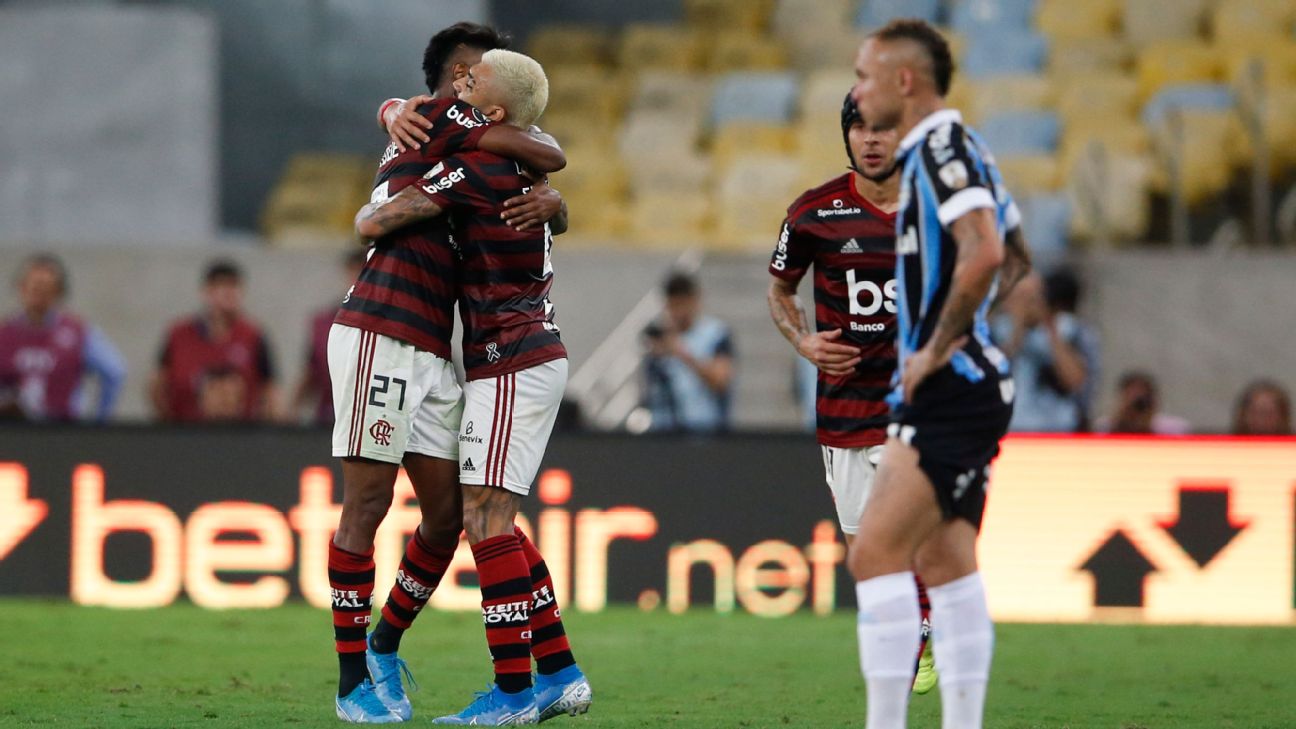 Bruno Henrique of Brazil's Flamengo, left, embraces teammate Gabriel after scoring a goal against Gremio.