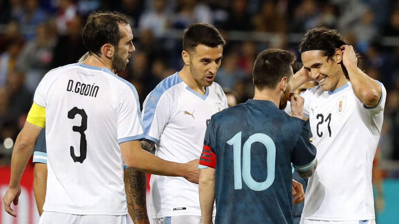Argentina's forward Lionel Messi talks to Uruguay's forward Edinson Cavani Argentina's forward Lionel Messi talks to Uruguay's forward Edinson Cavani
