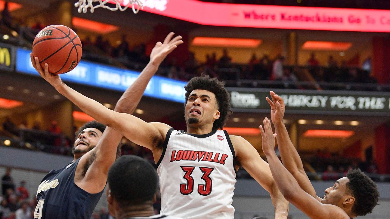 Auburn guard J'Von McCormick, right, goes to the basket as Kansas guard Devon  Dotson (11) defends during the second half of a second-round game in the  NCAA men's college basketball tournament Saturday