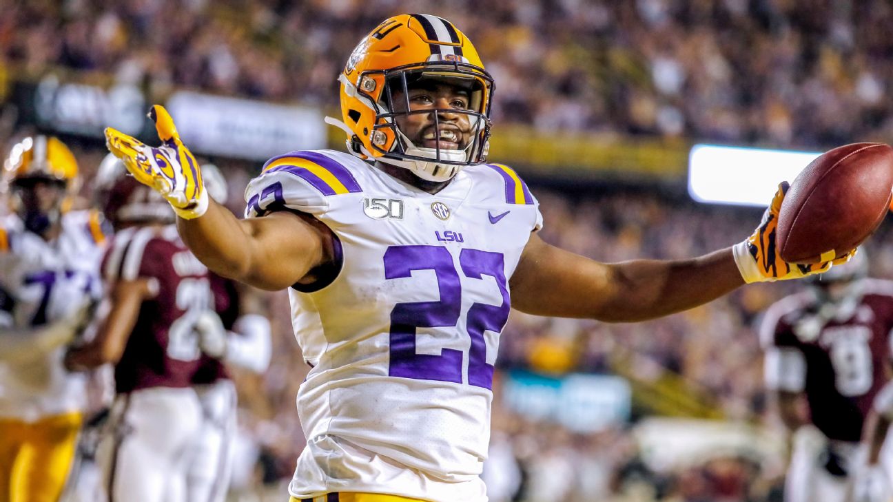 Clyde Edwards-Helaire LSU Tigers Unsigned White Jersey Rushing With Ball  vs. Auburn Photograph