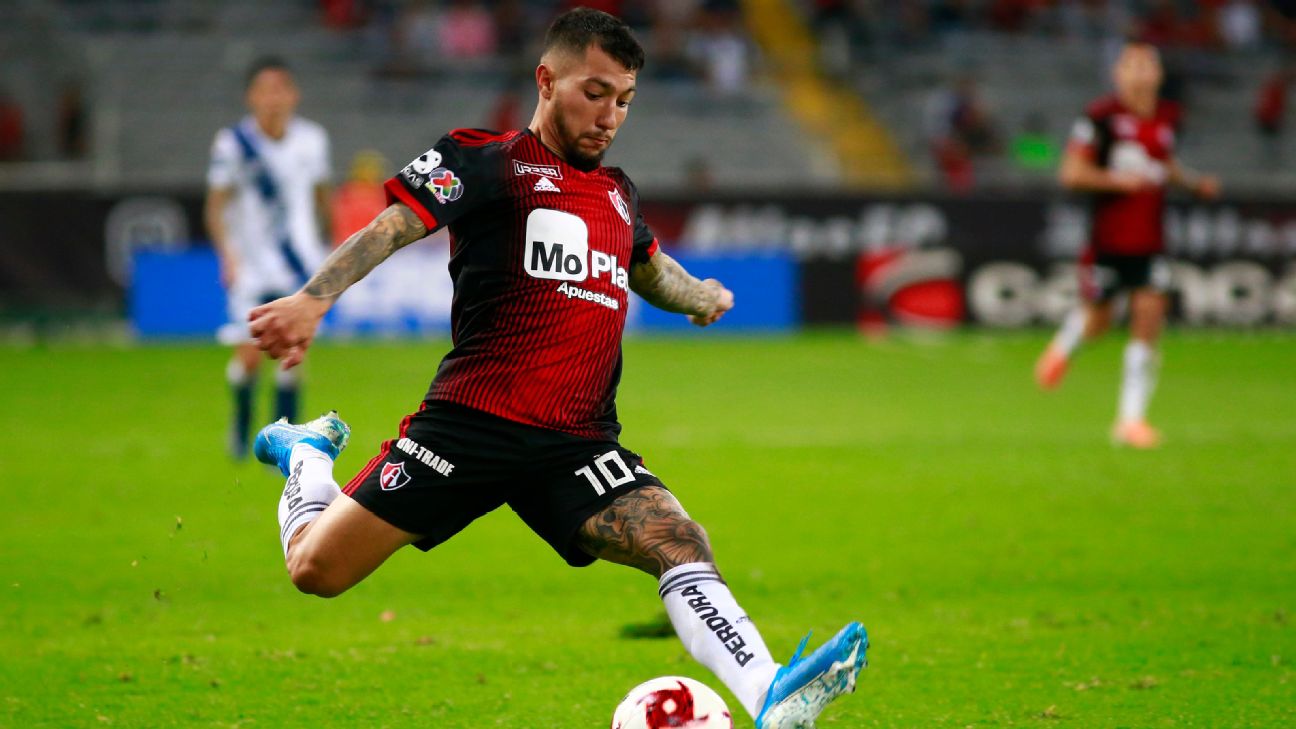 Luciano Acosta strikes the ball during Atlas' Liga MX match against Puebla. Luciano Acosta strikes the ball during Atlas' Liga MX match against Puebla.