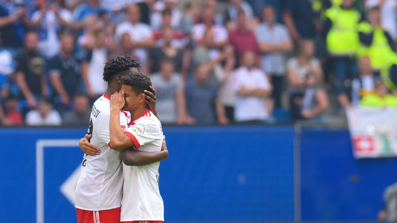 Hamburg players console one another following their relegation from the Bundesliga in 2017-18. Hamburg players console one another following their relegation from the Bundesliga in 2017-18.