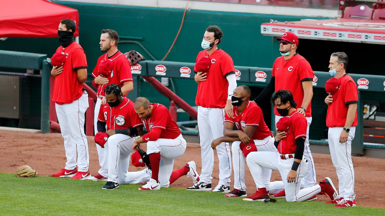 members of the St. Louis Cardinals stand for the National Anthem