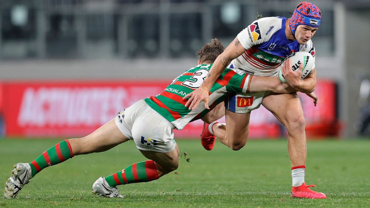 Billy Smith of the Roosters is tackled by Mitch Kenny (left) and