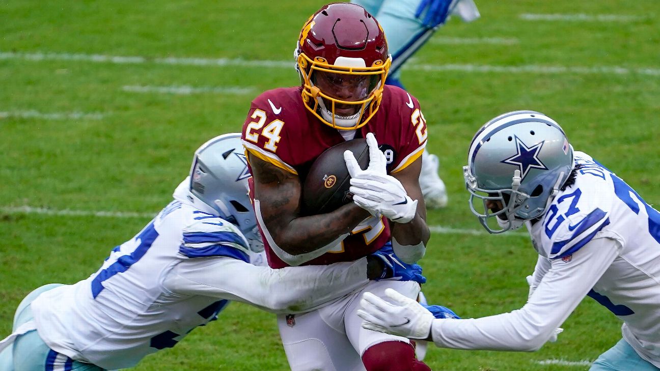 Washington Commanders running back Antonio Gibson (24) runs with