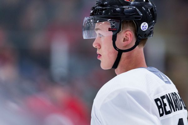 2 North Dakota hockey players kneel for anthem