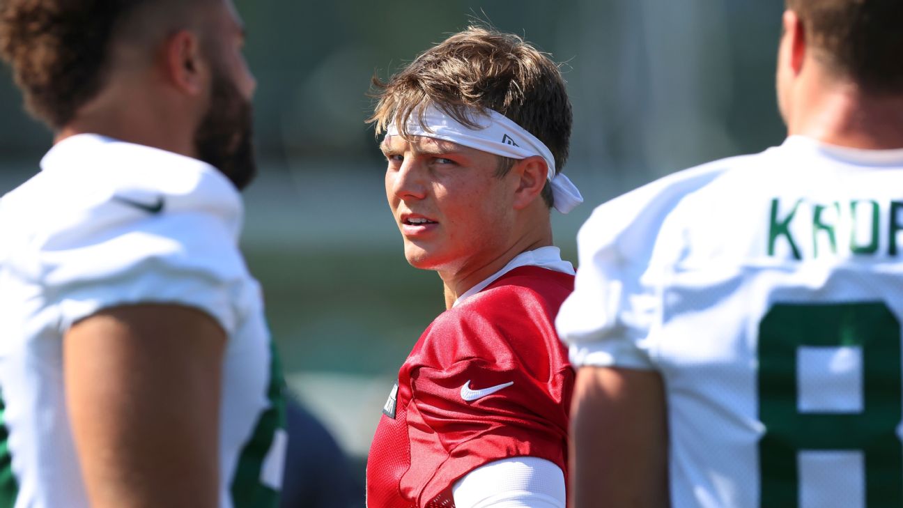 New York Jets quarterback Zach Wilson (2), offensive coordinator Mike  LaFleur and quarterback Mike White (5) make their way to a joint NFL  football training camp practice with the Green Bay Packers