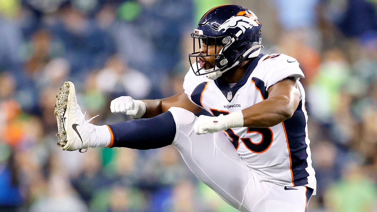 Denver Broncos linebacker Jonathon Cooper, right, is blocked by