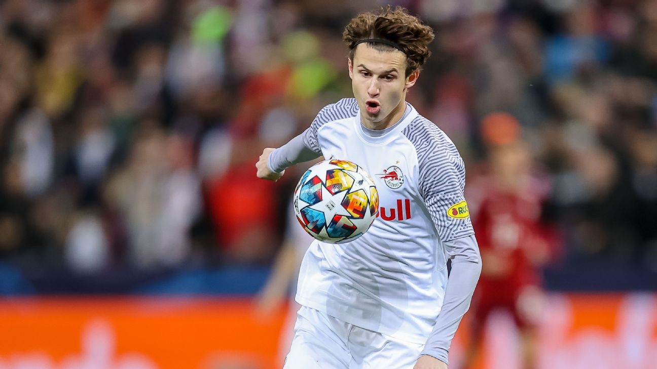 Leipzig's Benjamin Sesko, top, heads the ball during the German