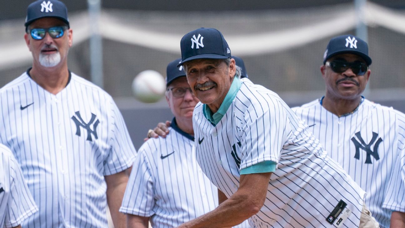 New York Yankees' Reggie Jackson is greeted at the dugout after