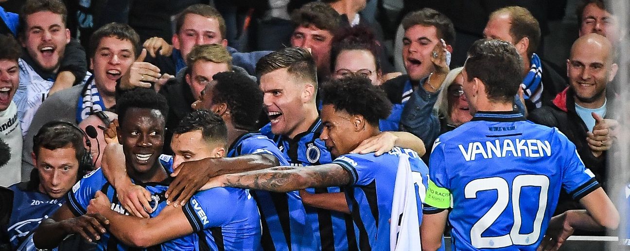 Club Brugge fans in the stands celebrate the result after the