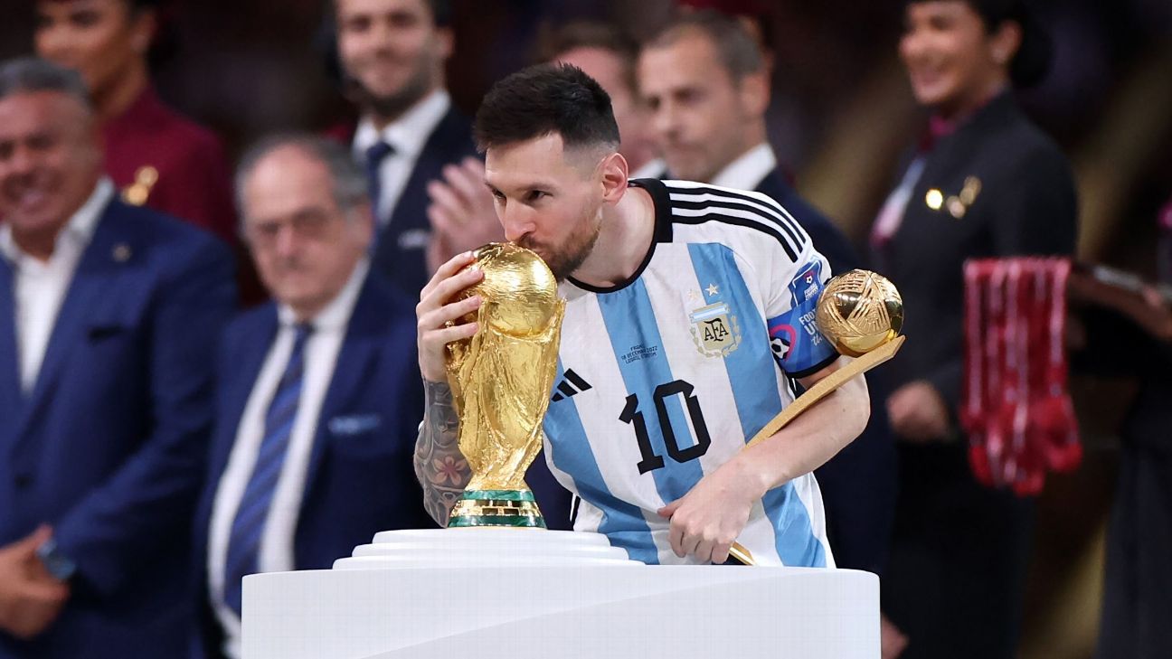 Lionel Messi Kisses His Trophy While Celebrating Win at FIFA World