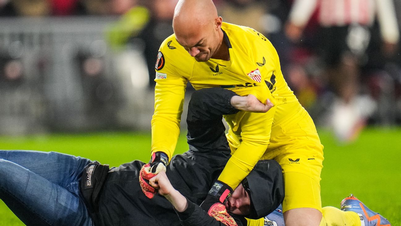 Pitch invader punches Sevilla keeper Dmitrovic