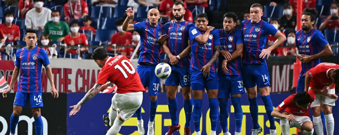 Al Hilal's Ali Al Bulayhi, right, fights for the ball with Urawa