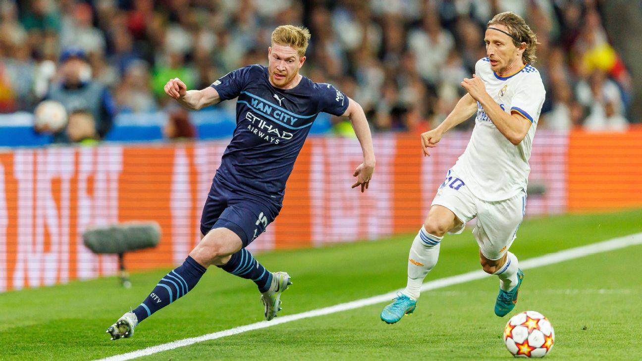 Real Madrid's Luka Modric, right, heads the ball past Manchester