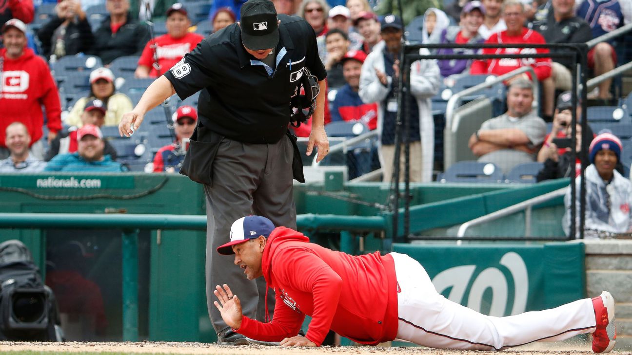 Washington Nationals manager Dave Martinez walks to the dugout after making  a pitching change during the ninth inning of a baseball game against the  Cincinnati Reds Friday, Aug. 4, 2023, in Cincinnati. (