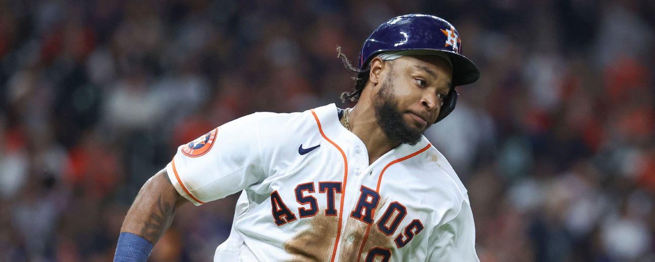 Houston Astros' Corey Julks, left, slides to score behind Atlanta