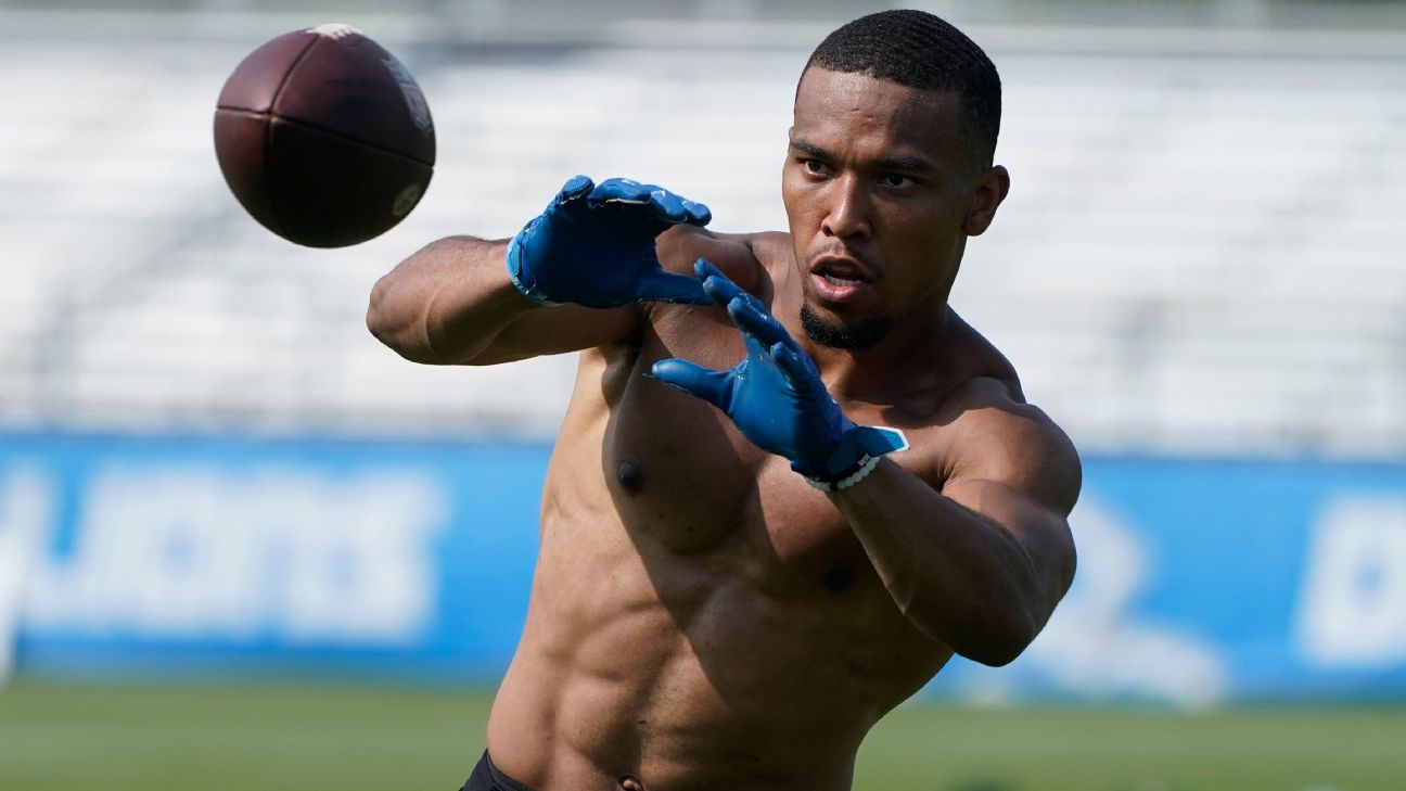 Amon-Ra St. Brown of the Detroit Lions carries the ball against