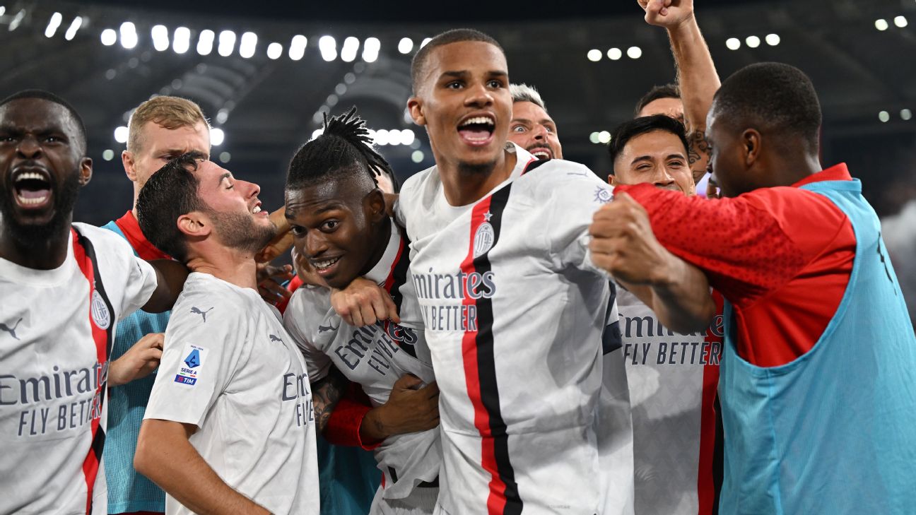 Rafael Leao celebrates with teammates after scoring Milan's second goal in their win over Roma.