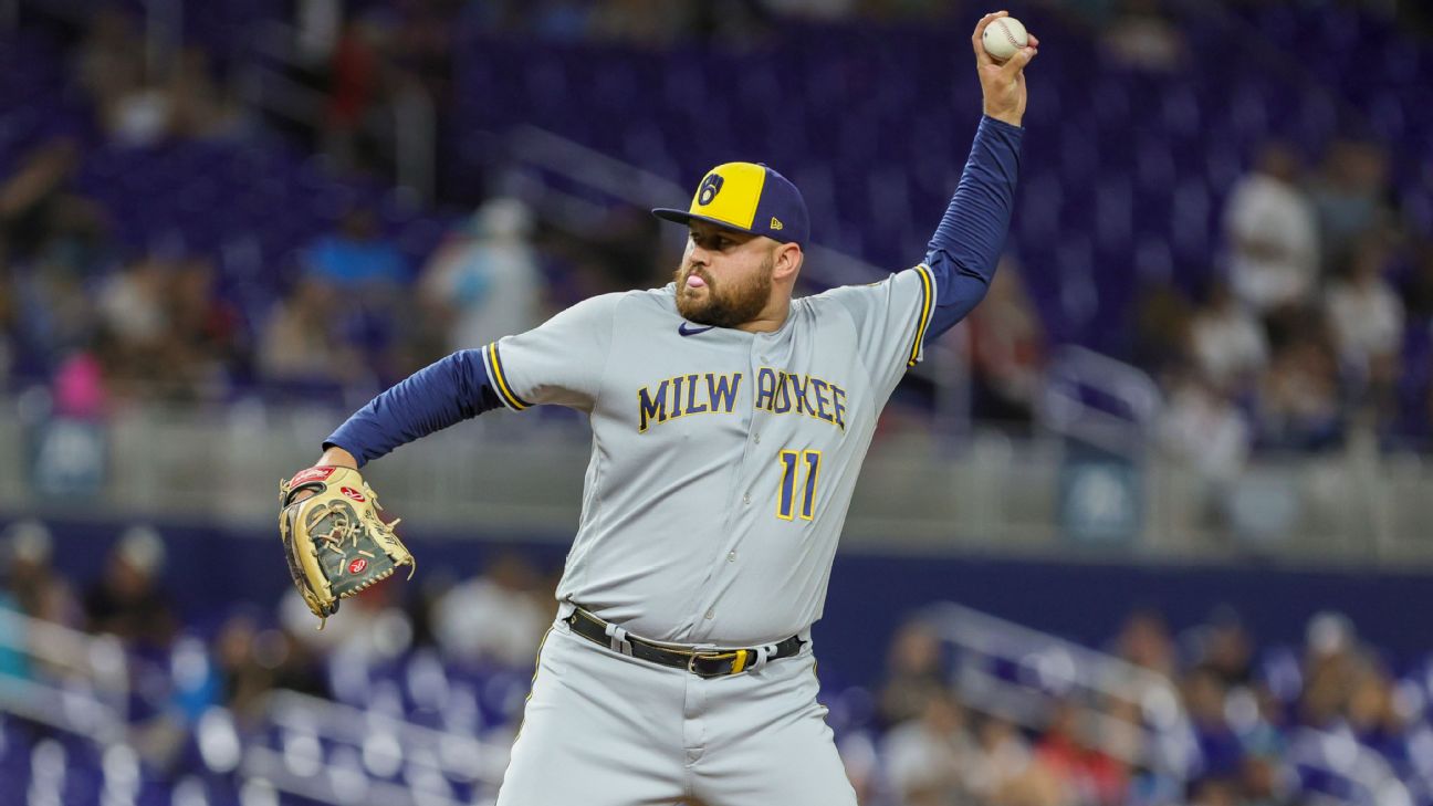 Milwaukee Brewers first baseman Rowdy Tellez, center, lobs the