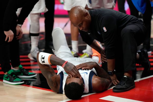 Kyrie injured as Powell lands hard on his foot