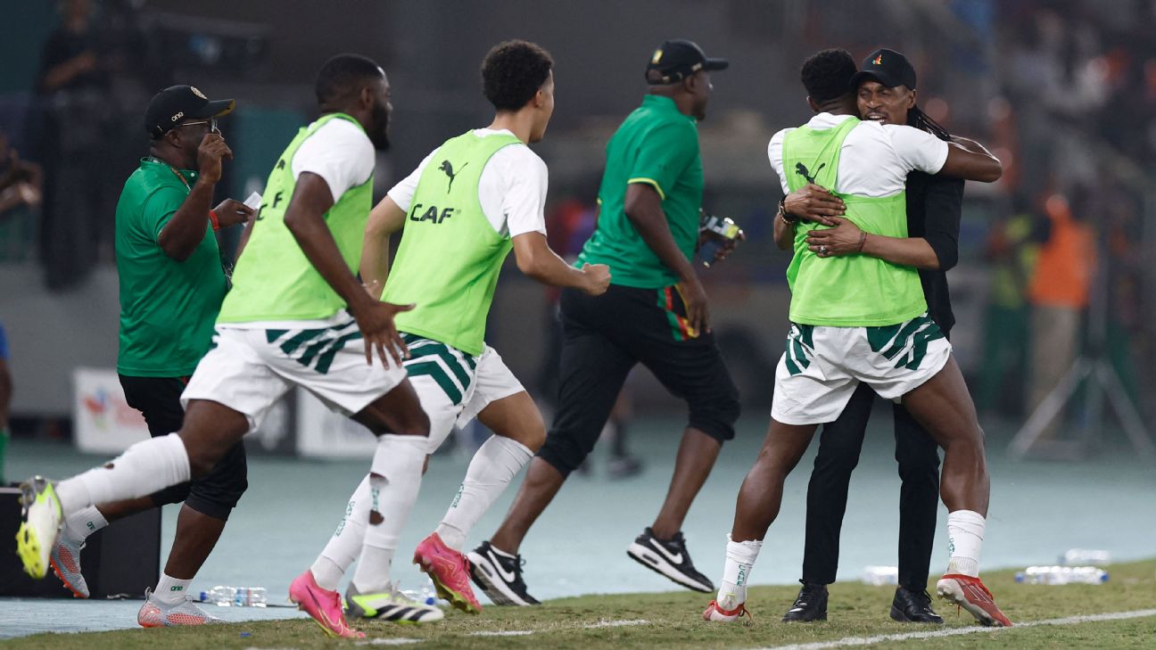 Cameroon players celebrate after scoring the winning goal against Gambia in their final group match at AFCON.