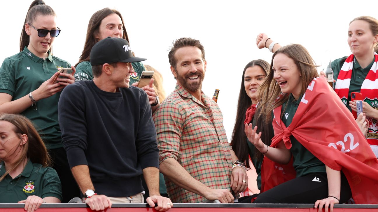 Ryan Reynolds, Co-Owner of Wrexham, and Rob McElhenney, Co-Owner of Wrexham, celebrate with players of Wrexham Men and Women during a Wrexham FC Bus Parade [1296x729]