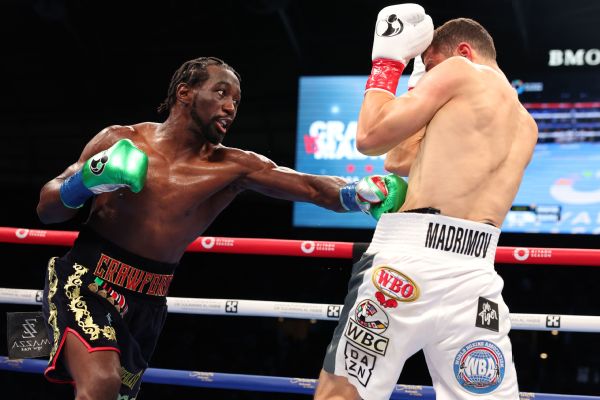 Crawford ekes out decision, now 4-weight champ