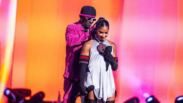 Flavor Flav gifts Jordan Chiles a bronze clock while at the 2024 MTV Video Music Awards. — Article image accompanying SHE Weekend: Flavor Flav's Las Vegas celebration of women's sports on WagerUp Sports News.