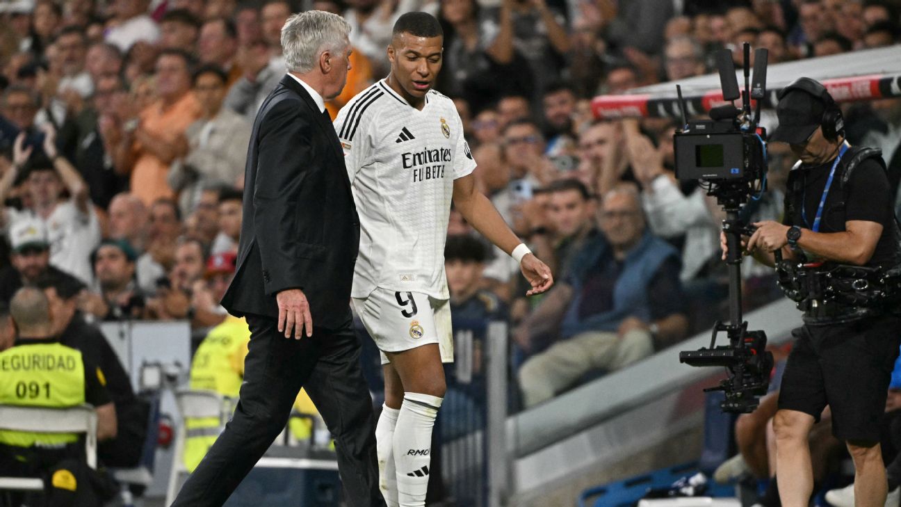 Kylian Mbappe talks with Real Madrid's Italian coach Carlo Ancelotti as he leaves the pitch during the Spanish league football match between Real Madrid CF and Deportivo Alaves
 [1296x729]