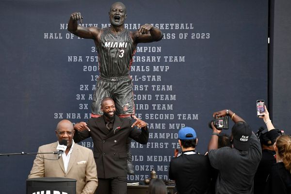 Former Heat star Dwyane Wade poses at his statue unveiling ceremony outside Kaseya Center in Miami on Sunday.