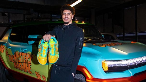 LaMelo Ball poses with his Puma's next to a truck reminiscent of the 'Mystery Machine.'