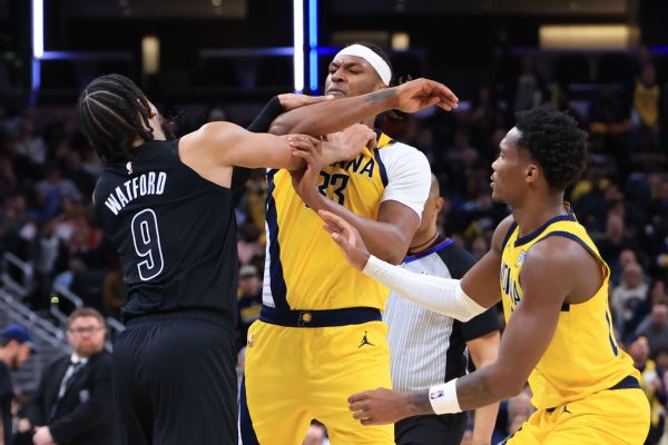 The Nets' Trendon Watford (No. 9) shoves the Pacers' Myles Turner on Thursday.