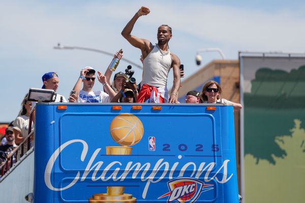 Thunder guard Shai Gilgeous-Alexander gestures to the crowd as the team celebrates its first NBA Finals title win with a parade through downtown Oklahoma City on Tuesday.
