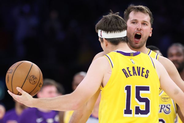 Luka Doncic, who hit the winning jumper in overtime, celebrates with Austin Reaves, who forced the extra frame when he rebounded an intentionally missed free throw before sinking the tying bucket.