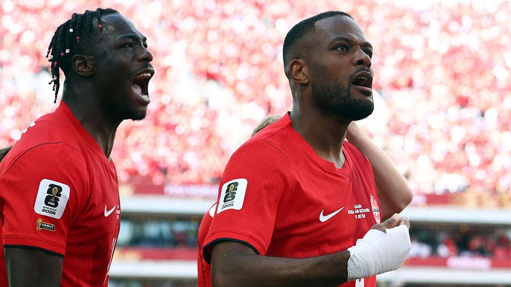 Cyle Larin, right, celebrates after scoring a game for Canada in their opening match against Bosnia.