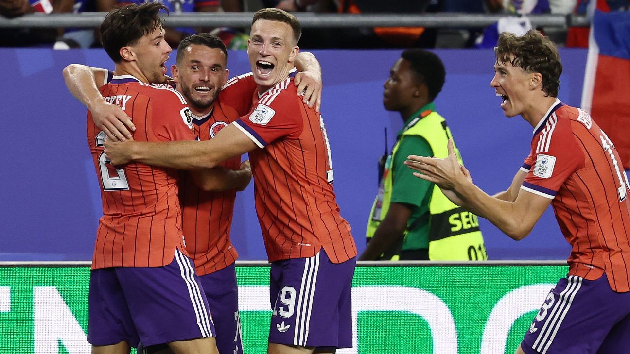 John McGinn (2nd L) celebrates with Scotland teammates after against Haiti.