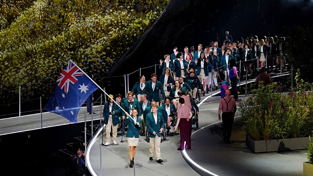 Nina Kennedy, flag bearer of Australia walking into the arena with their teammates during the opening ceremony for the 2026 Commonwealth Games. — Article image accompanying Golden Glasgow: Aussies' lofty goals for new-look Games on WagerUp Sports News.