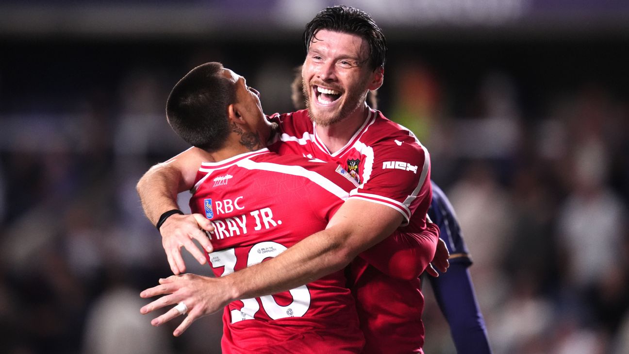 Wrexham's Kieffer Moore (right) celebrates his side's third goal against Millwall with teammate Danny Imray.