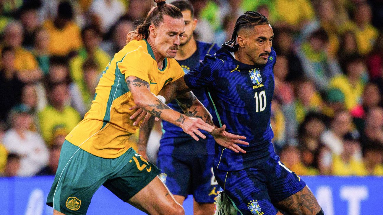 Brazil's Raphinha (R) and Australia's Jackson Irvine compete for the ball. — Article image accompanying Barcelona await updates after Brazil's Raphinha substituted due to thigh discomfort on WagerUp Sports News. Brazil's Raphinha (R) and Australia's Jackson Irvine compete for the ball. — Article image accompanying Barcelona await updates after Brazil's Raphinha substituted due to thigh discomfort on WagerUp Sports News.